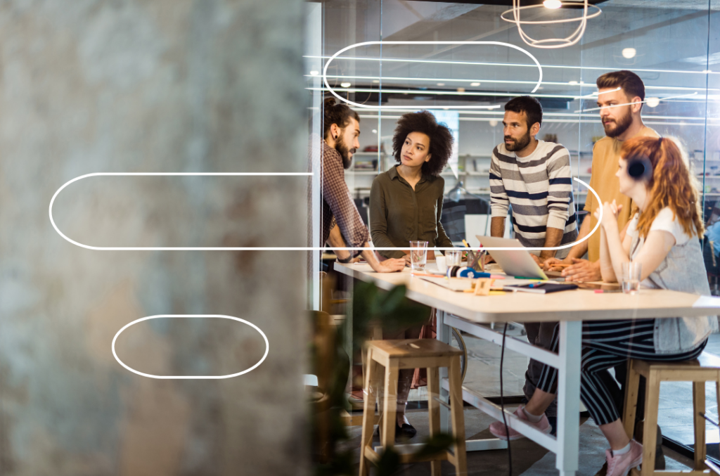 Colleague discussion within a meeting room with CoreStream GRC logo overlay