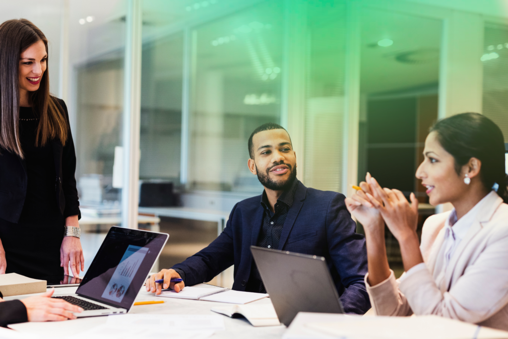 casual group discussion in meeting room with green gradient overlay
